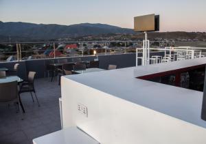 a bar on the roof of a building with a view at Airport View Hotel Songwe 