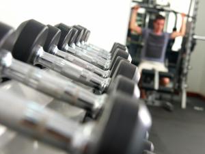 a row of dumbbells in a gym at Sara Beachfront Boutique Resort in Pathiu