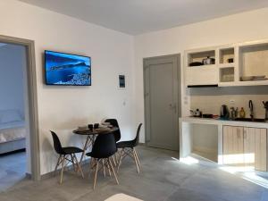 a kitchen and dining room with a table and chairs at IosAgnanti in Ios Chora