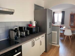 a kitchen with white cabinets and a counter top at Grand 2 pièces aux pieds des pistes in Valberg