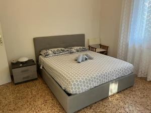 a bedroom with a bed and a nightstand and a bed sidx sidx sidx sidx at casa Alexander in Marina di Massa