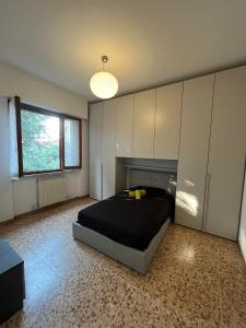 a bedroom with a bed in a room with cabinets at casa Alexander in Marina di Massa
