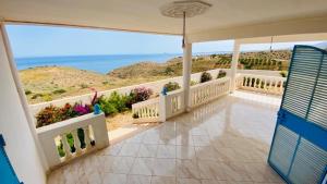 a balcony of a house with a view of the ocean at Villa en el campo sobre el mar in Ras El Ma