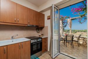 A kitchen or kitchenette at ARCHONTIKO VILLAGE VOLIMES 5' minutes from the shipwreck