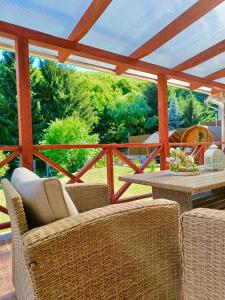 un patio con sillas de mimbre y una mesa en una terraza. en Relax Wellness Apartman, en Parádsasvár
