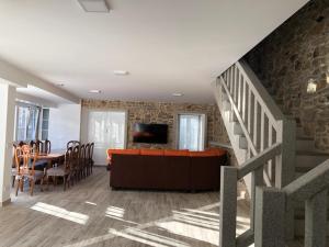 a living room with a staircase and a dining room at Casa A Braña in A Coruña