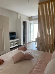 a bedroom with a bed with two pillows on it at Mary Home Sicily Deluxe in Ragusa