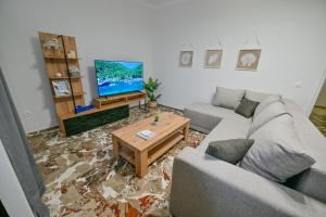 a living room with a couch and a coffee table at Blue Horizon Kisamos Deluxe Apartment in Kissamos