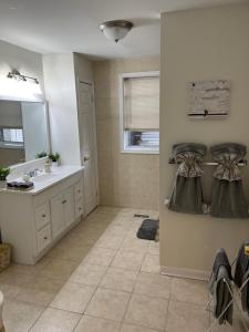 a bathroom with a sink and a mirror at Cozy Home located in a prime area. in Philadelphia