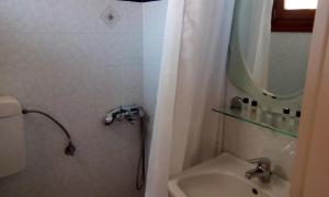 a bathroom with a shower and a sink at Ενάλιον in Astypalaia +16 photos