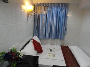 Llit o llits en una habitació de Dhillon Hotel -Guest House & Hostel