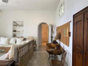 a living room with a bed and a couch at Casa Capperina in Malfa