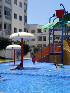a group of people playing in a swimming pool at Appartement la Siesta beach resort Mohammedia in Mohammedia