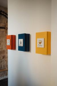 a wall with four books on a wall at La Dimora dei WaLori in Bisceglie