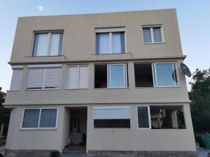a house with many windows on the side of it at IgMAN apartments Tivat in Tivat
