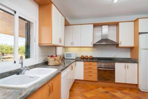 A kitchen or kitchenette at Can Rafelino, pool and relax