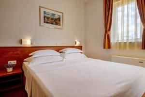 Postel nebo postele na pokoji v ubytování Hotel Posejdon