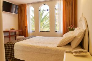 Postel nebo postele na pokoji v ubytování Astorga Hotel Arequipa