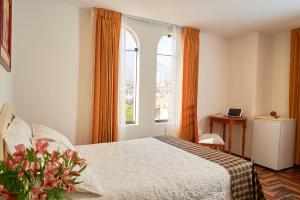 Postel nebo postele na pokoji v ubytování Astorga Hotel Arequipa