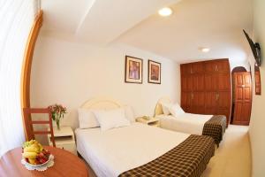 Postel nebo postele na pokoji v ubytování Astorga Hotel Arequipa
