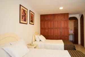 Postel nebo postele na pokoji v ubytování Astorga Hotel Arequipa