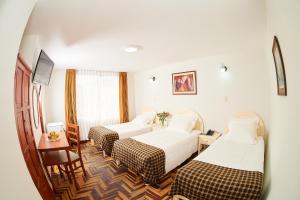 Postel nebo postele na pokoji v ubytování Astorga Hotel Arequipa