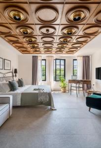 a bedroom with a bed and a wooden ceiling at Bridges Residence in Veliko Tŭrnovo