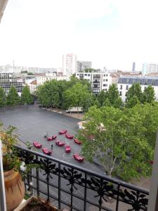 a view of a parking lot with red chairs at Vue sur les toits de Paris, tour Effeil, centre malakoff, chambre chez l'habitant, sans ascenseur, à deux pas de Paris in Malakoff