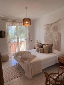 a bedroom with a large bed and a large window at La Farfalla in Fossacesia