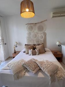 a bedroom with a large white bed with a large headboard at La Farfalla in Fossacesia