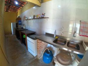 a kitchen with a sink and a counter top at Pires House Beach Maramar in Luis Correia