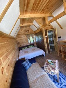 a bedroom with a bed and a couch in a room at Durmitor Bungalows in Žabljak