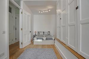 a bedroom with white walls and a bed with a rug at 331 in London