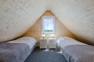 dwa łóżka w pokoju z oknem w obiekcie Willa Mycyny oraz domki w mieście Mycyny