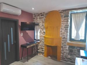 a room with a room with a surfboard on the wall at Theokleia_guest house in Kavála