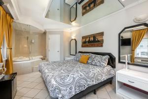 a bedroom with a large bed and a bath tub at Samesun Montreal Hotel & Hostel in Montreal +58 photos