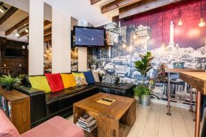 a living room with a couch and a tv at Samesun Montreal Hotel & Hostel in Montreal