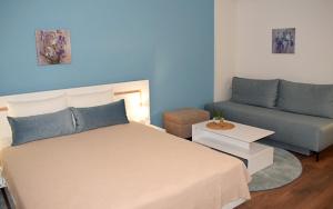 a bedroom with a bed and a couch at Iris Guesthouse in Ohrid