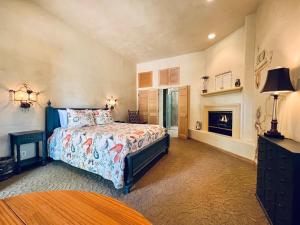 a large bedroom with a bed and a fireplace at Petit Logis Inn in Yountville