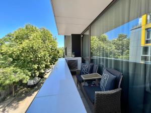 a patio with a table and chairs on a balcony at City Center Apartments in Plovdiv