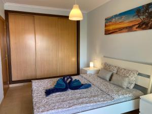 a bedroom with a bed with a pair of shoes on it at Family Heaven - No Stress Holidays in El Cotillo