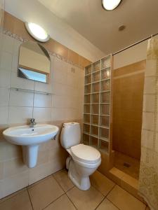 a bathroom with a toilet and a sink at "Kubania" POKOJE GOŚCINNE in Mielno +14 photos