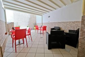 a restaurant with red chairs and tables on a patio at Il Porto Affittacamere b&b in Brindisi