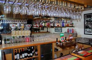 a bar with lots of wine glasses and bottles at Sandown Regency Hotel & Apartments in Noble Park