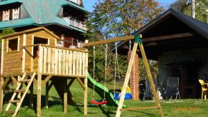 a playground with a tree house and a swing at Willa Widok in Bukowina Tatrzańska
