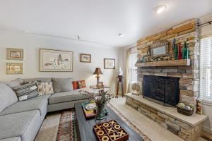 a living room with a couch and a fireplace at Park Ave Manor 3B in Park City