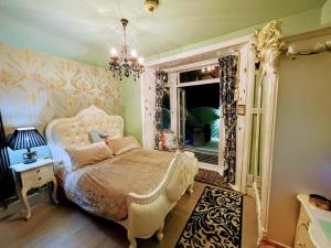 a bedroom with a white bed and a window at The Mirador Boutique Town House in Swansea