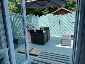 an outside view of a patio with an umbrella at The Mirador Boutique Town House in Swansea