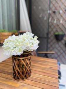 a vase filled with white flowers sitting on a table at City Center Apartments in Plovdiv