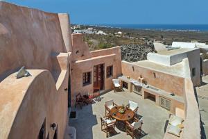 an aerial view of a building with tables and chairs at Villa Amalia by Thireon in Oia